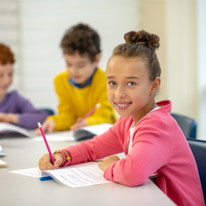 Elementary school children learning with their reading workbooks
